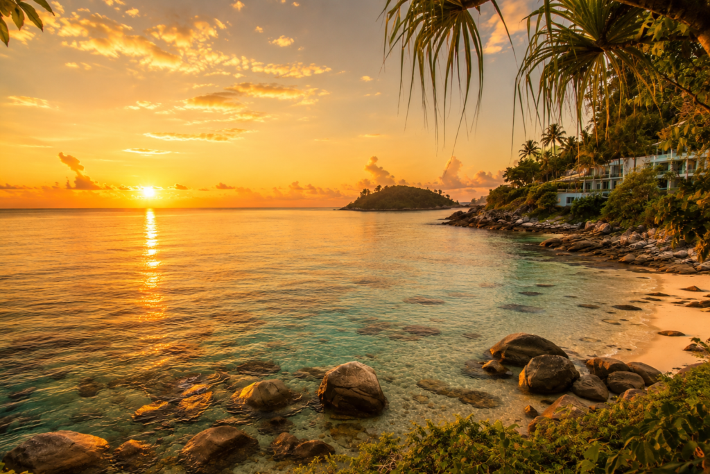 Sunrise on a Phuket beach with golden light and calm sea