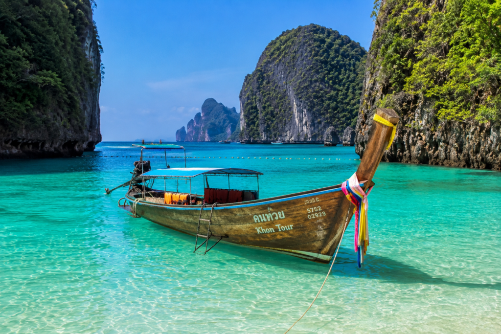 Traditional Thai longtail boat near tropical islands in Phuket